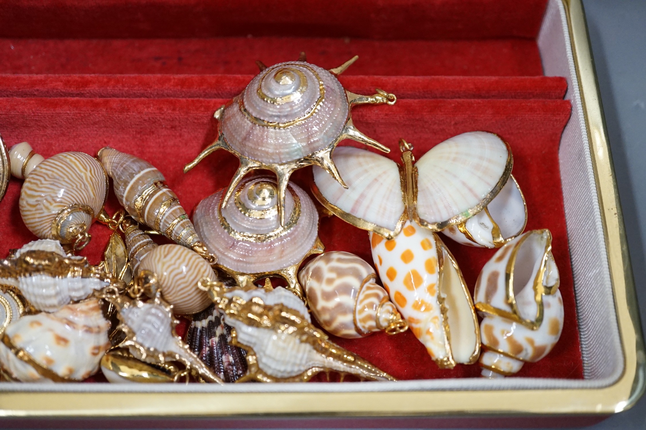 A small group of assorted gilt mounted sea shell pendants. largest 69mm.